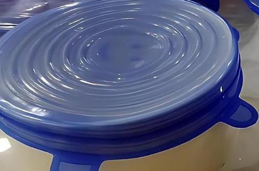 Blue silicone lid stretched over a deep bowl